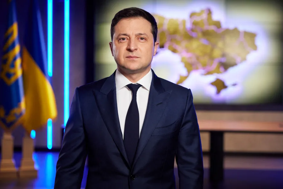 Volodymyr Zelensky giving a speech after Russia's recognition of the independence of occupied Donbass.  In the background is a map of Ukraine within its internationally recognized borders, including Crimea